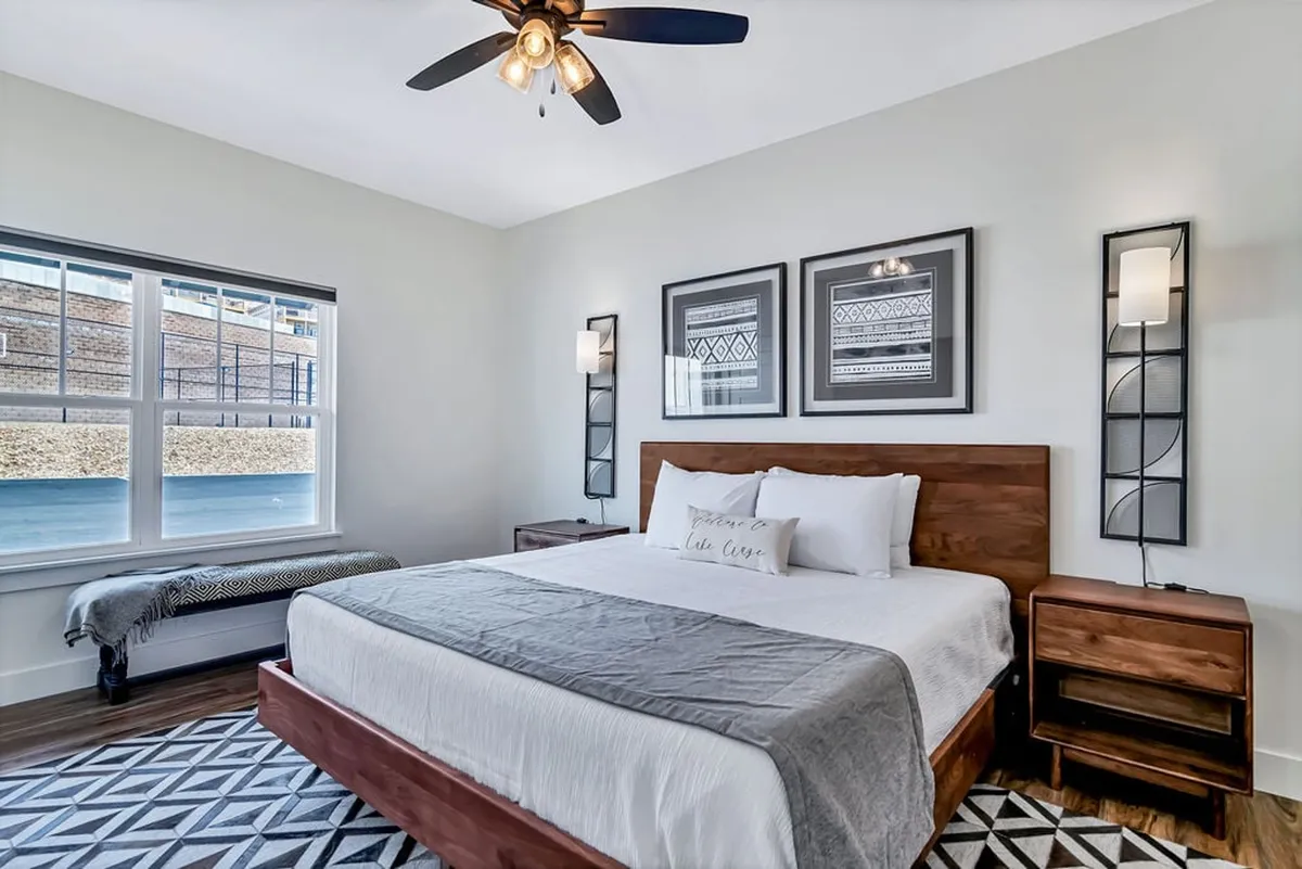 A bunk room designed with a cozy bed, stylish wall art, a window, and nightstands. The space feels calm, playful, and ideal for children to relax and recharge.