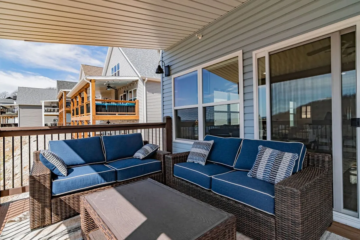 A comfortable outdoor seating setup with cushioned chairs and a coffee table, offering a tranquil spot for relaxing, sipping drinks, and enjoying distant views. The area looks inviting for both casual mornings and evening gatherings.